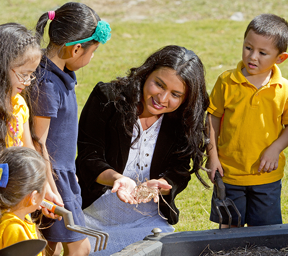 Iris Silva works with fourth-graders during a science enrichment event.