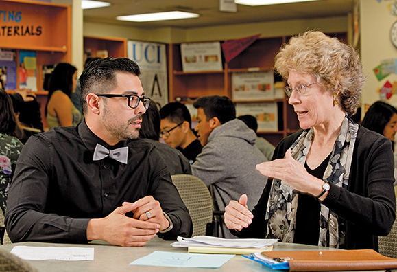 Sara Lundquist, vice president of student services at Santa Ana College, is the recognized leader of the Santa Ana Partnership. Here, she talks with Javier Valdez, a counselor at Valley High School.