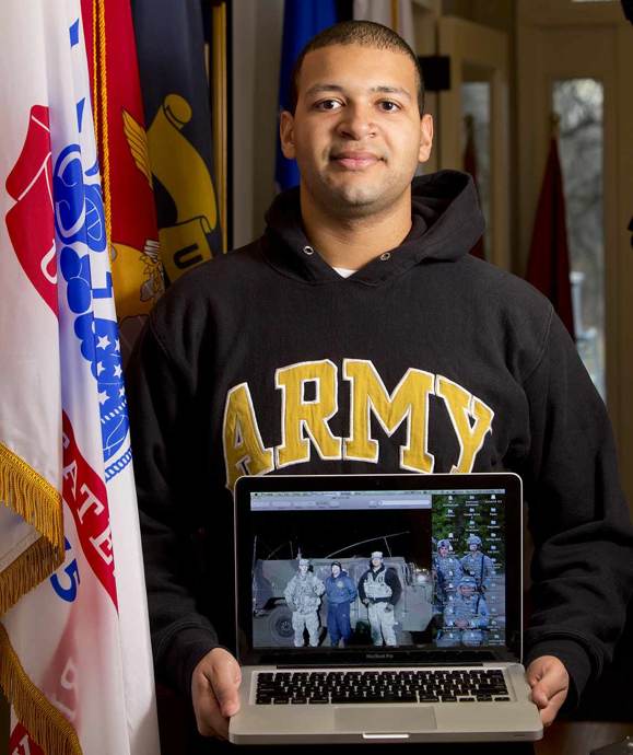 Rutgers University student Walfrin (Wally) Batista displays an image of his unit when it was deployed last fall in response to Hurricane Sandy. Many student veterans, including Batista, are in the Reserves and have been called to duty while attending school.