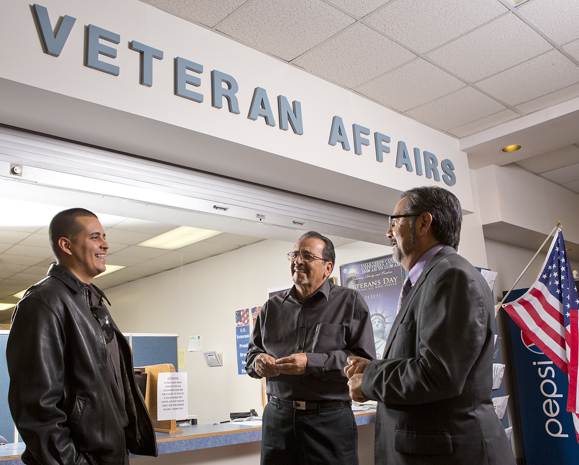 El Paso Community College graduate Adrian Acuña (left), who used his VA benefits to help pay for his degree, got help from a number of people on campus — including Francisco Guerra (center), assistant director of veterans affairs, and Raul Lerma, executive director of EPCC’s financial aid office.