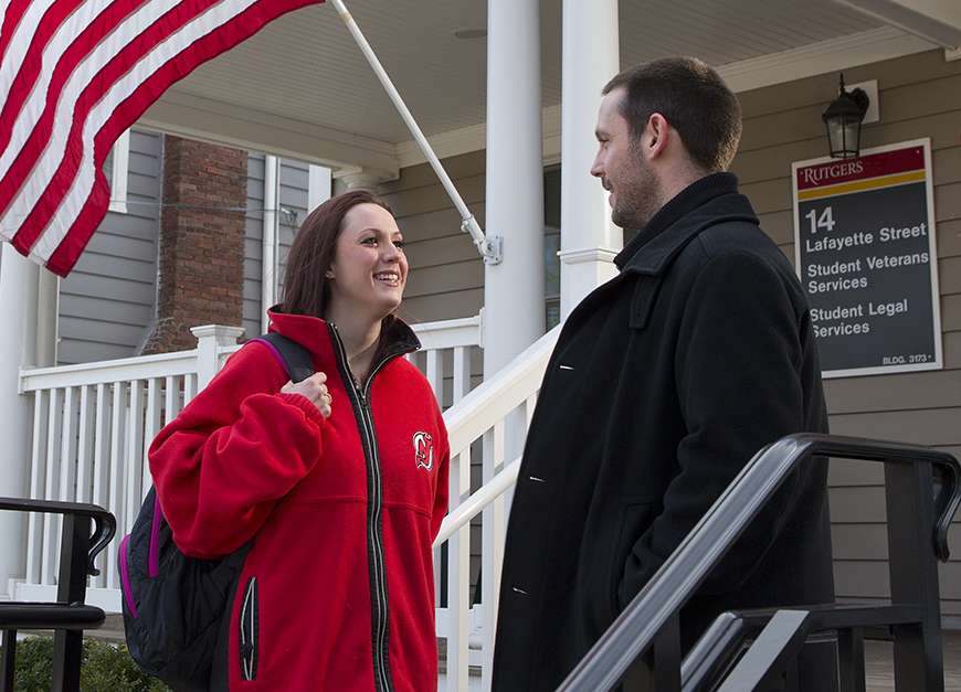 Rob Bright, a former Navy intelligence specialist, now serves as assistant director of Rutgers’ Office of Veterans & Military Programs & Services. Here, at the entrance to Veterans House on the Rutgers campus, Bright talks with Caitlin McCarthy, a four-year Marine Corps veteran who served in Iraq.